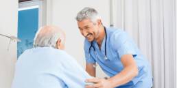 Why Having the Right Point of Care (POC) Devices is Essential for CMS’s New Patient Driven Payment Model (PDPM) Pioneer healthcare man in blue shirt with patient nurse with resident male nurse and male resident